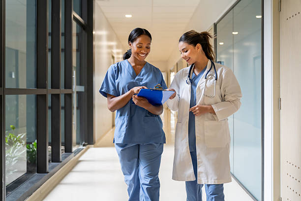 Nurse at the hospital showing tests results to a doctor and smiling.